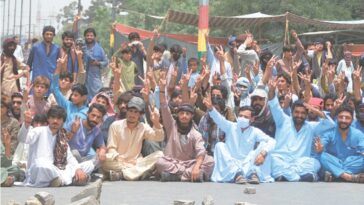 QUETTA: Baloch Yakjehti Committee supporters stage a sit-in on Sariab Road, in front of the Balochistan University, on Wednesday.—Adnan Ahmed